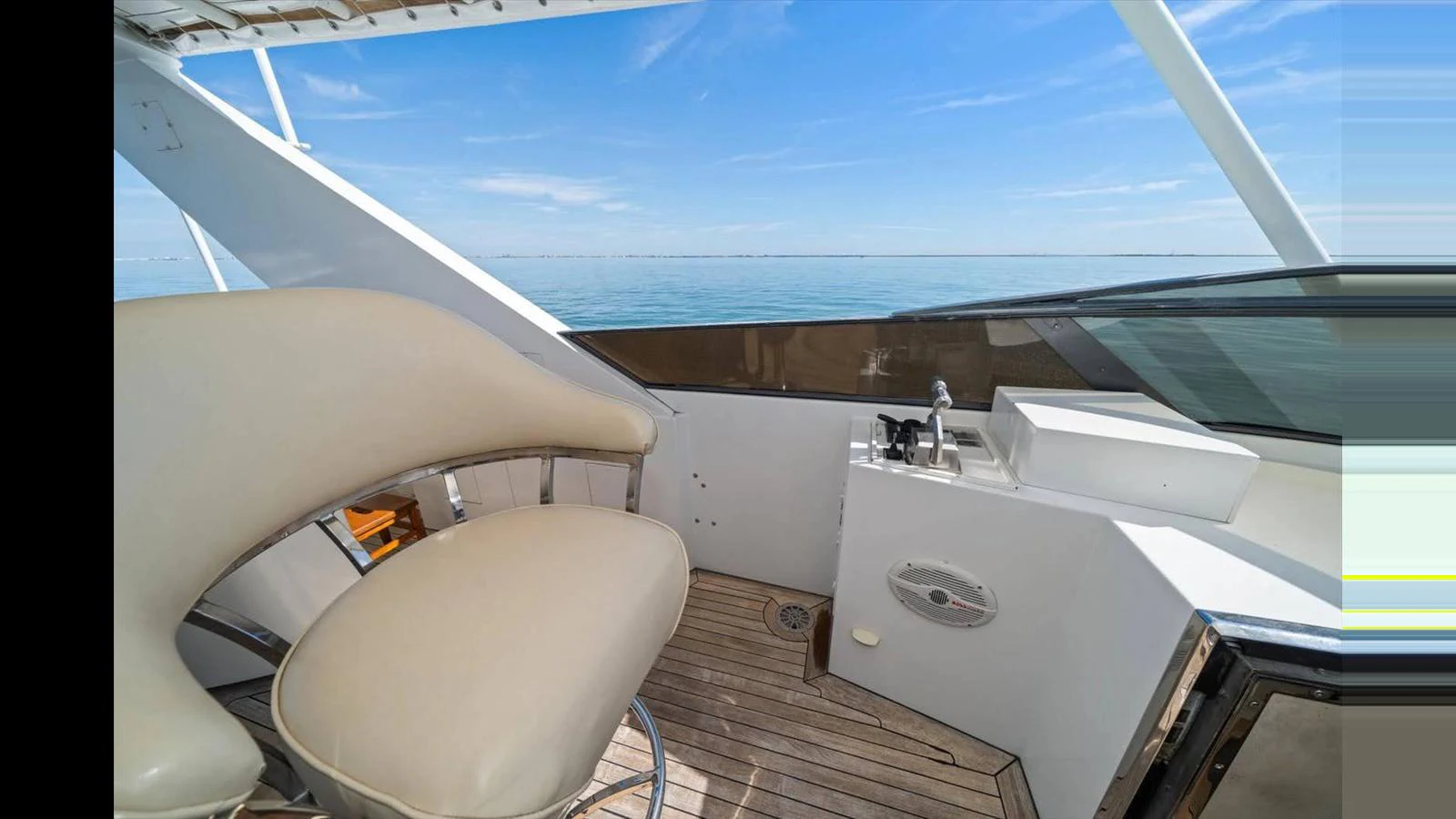 The yacht's helm offers a sleek and modern design with a comfortable seating area and a clear view of the open sea. aboard THINK B.I.G Yacht for Sale
