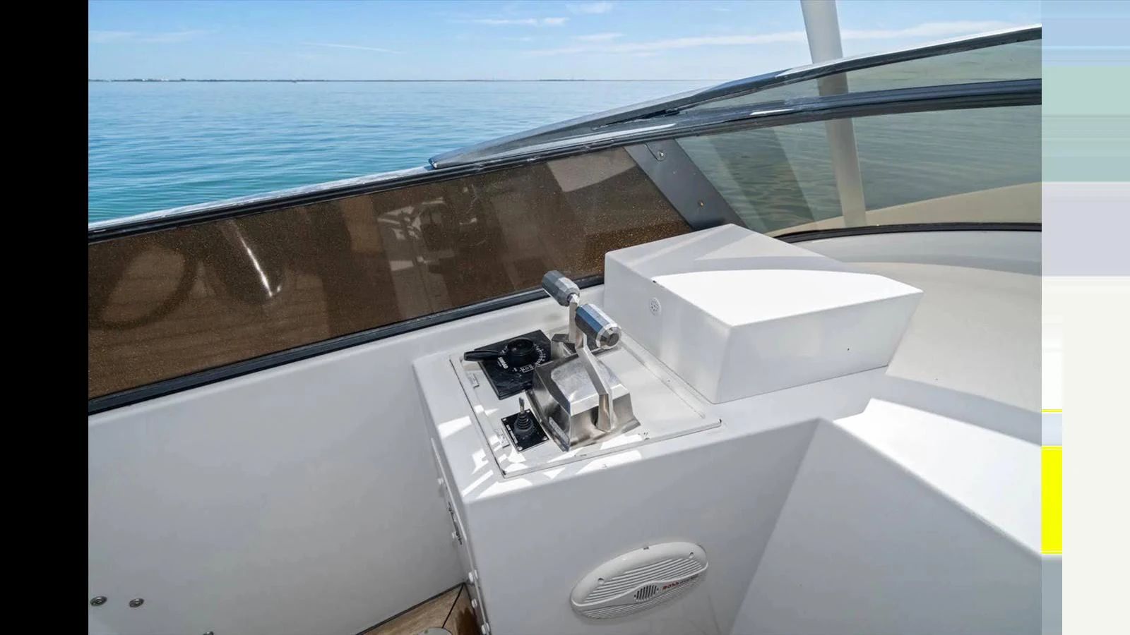 The helm station features modern controls and a clear view of the water. aboard THINK B.I.G Yacht for Sale