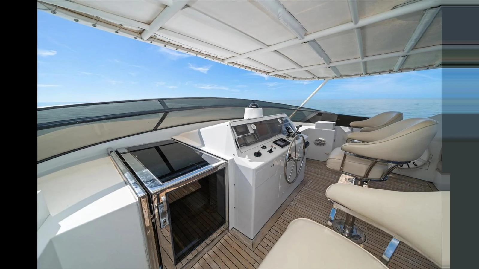 The yacht's helm offers a sleek and modern control area with comfortable seating and panoramic views. aboard THINK B.I.G Yacht for Sale
