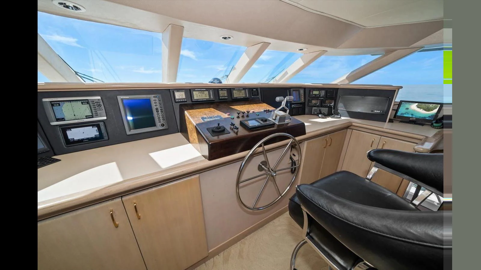 The helm station features state-of-the-art navigation equipment and luxurious seating. aboard THINK B.I.G Yacht for Sale
