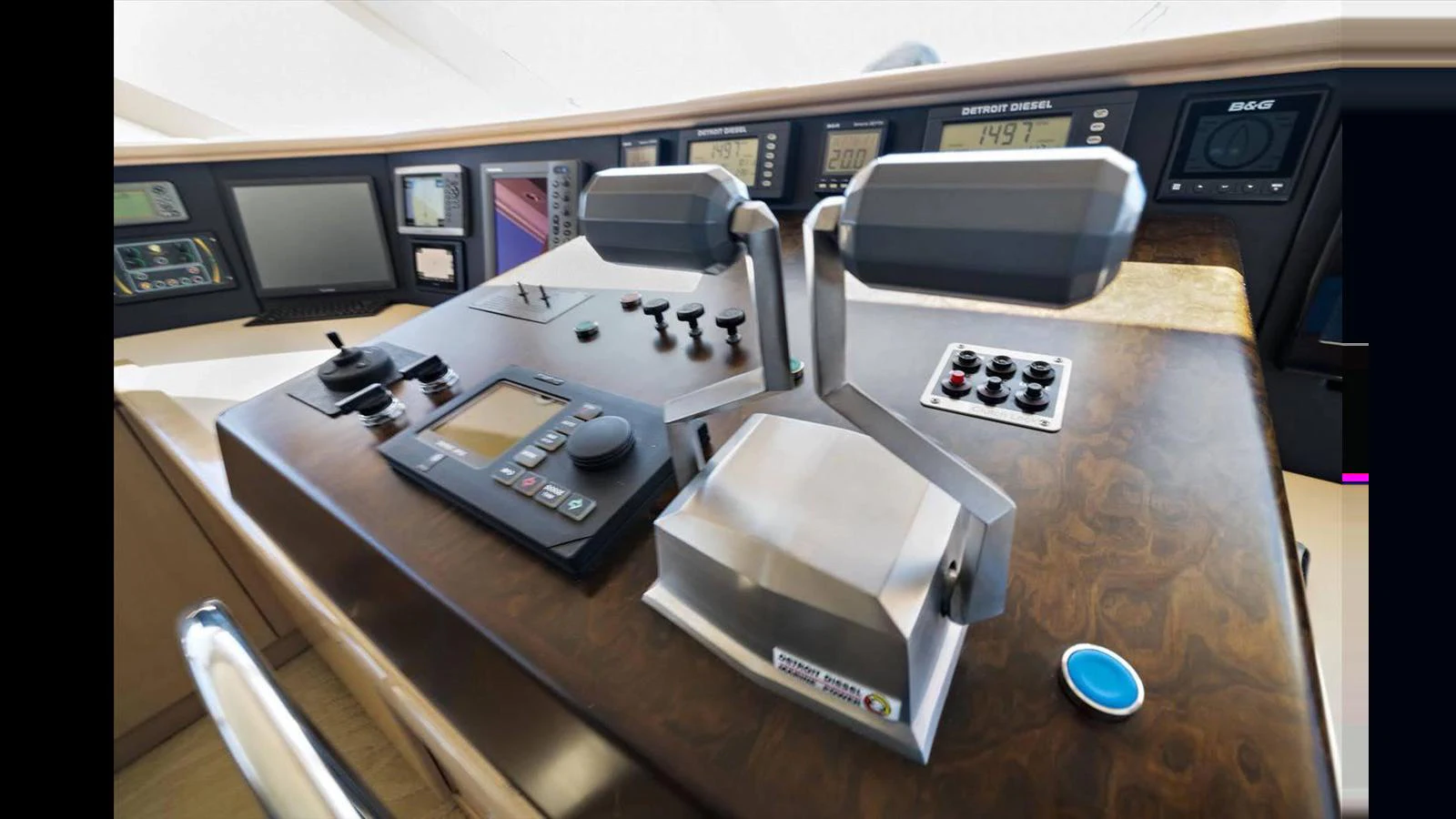 The helm station features advanced navigation and control systems with a sleek design. aboard THINK B.I.G Yacht for Sale