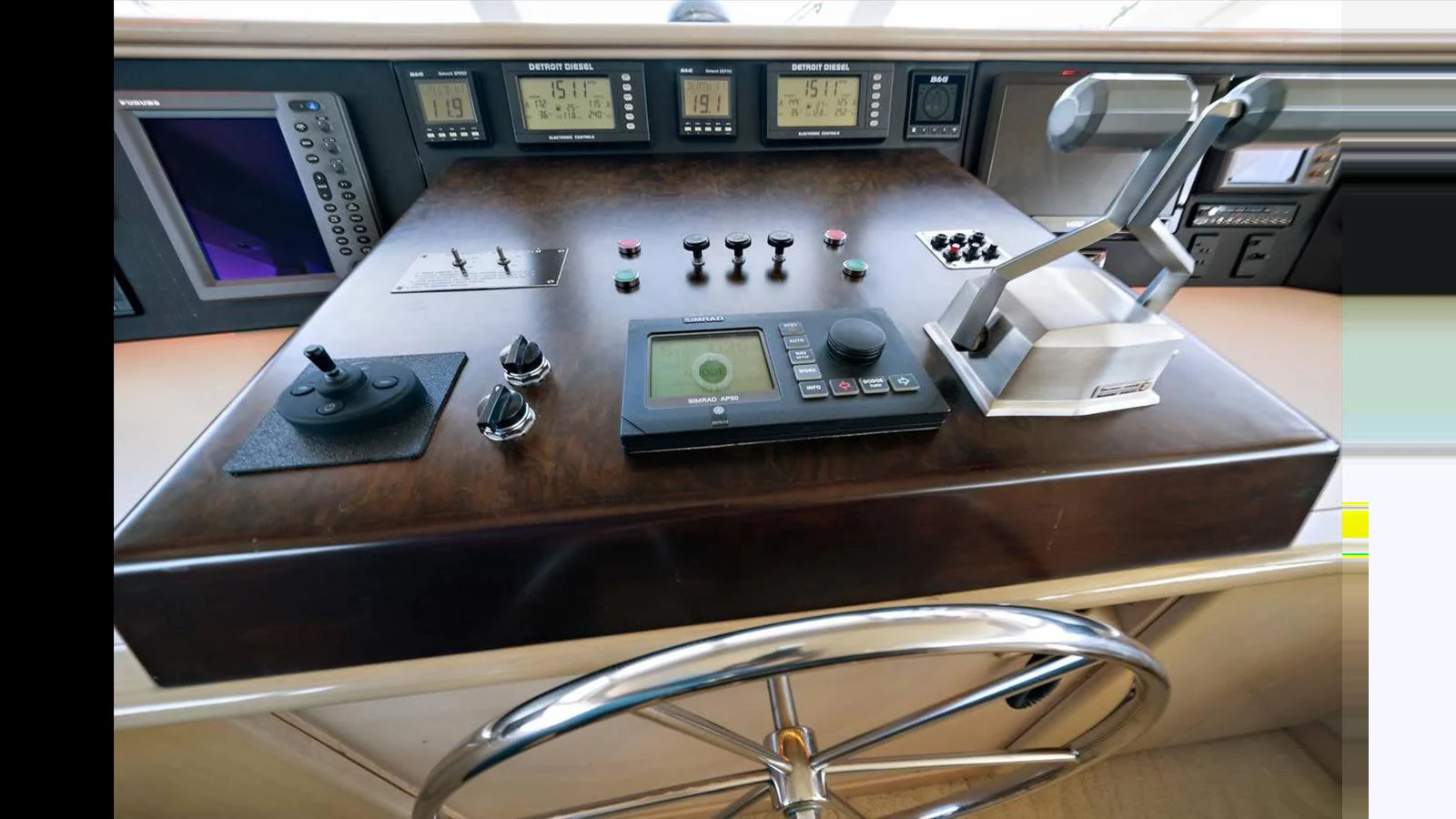 The helm station features advanced navigation and control equipment for precise maneuvering. aboard THINK B.I.G Yacht for Sale