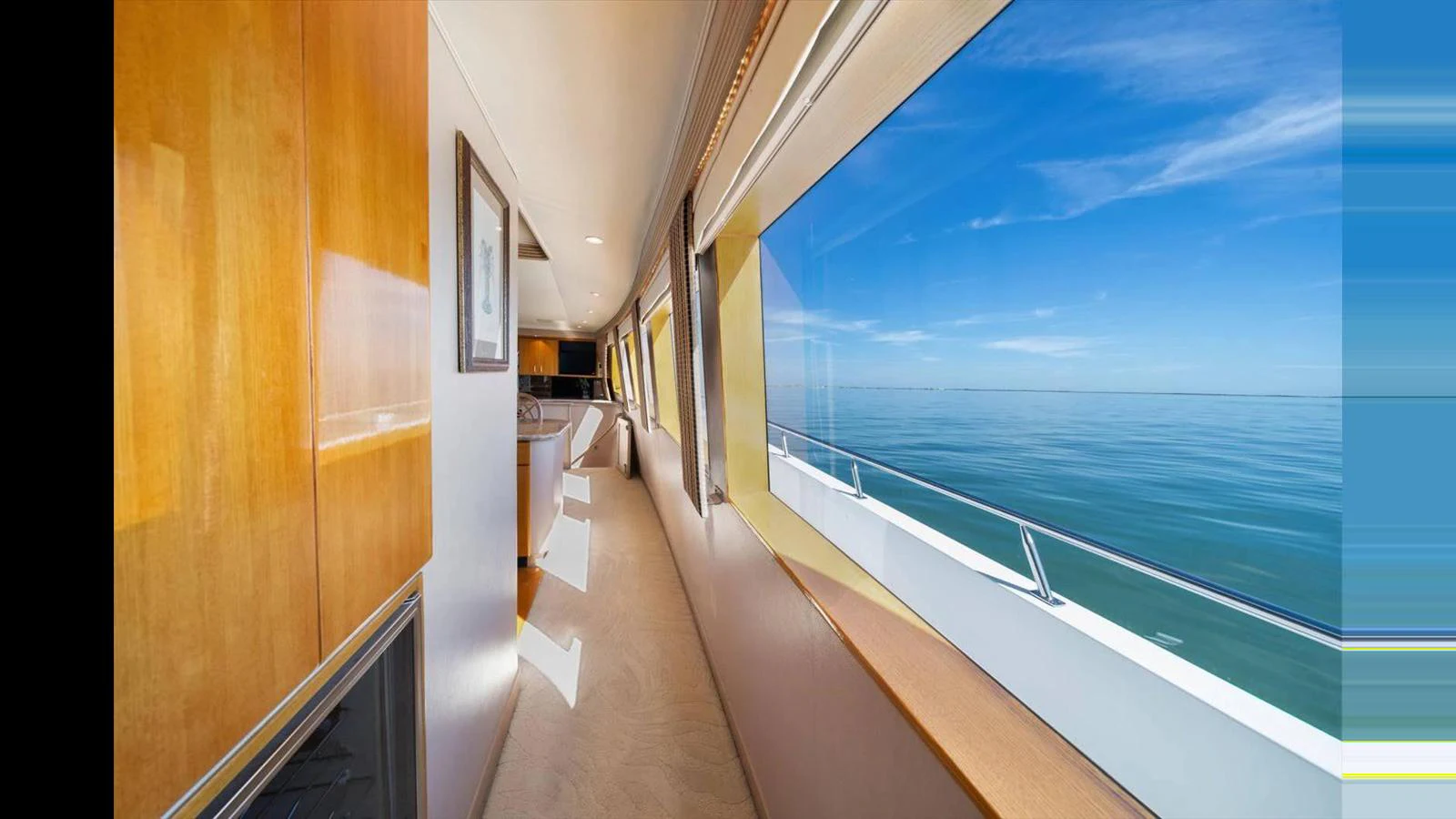 A bright and spacious hallway with large windows offering stunning ocean views. aboard THINK B.I.G Yacht for Sale