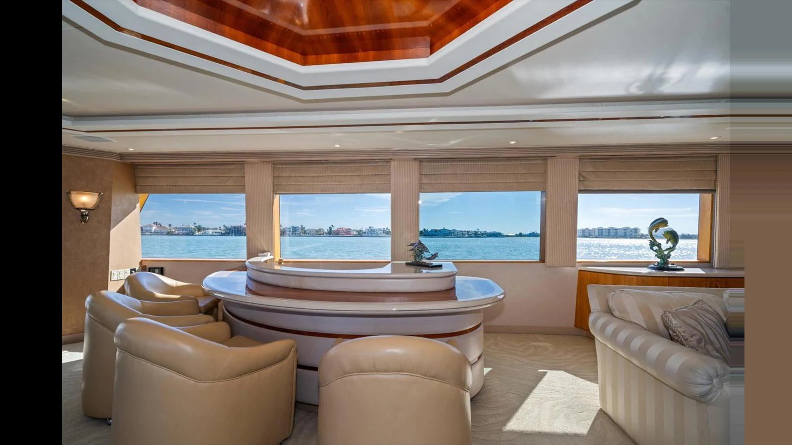 The yacht's salon features plush seating and expansive windows offering stunning water views. aboard THINK B.I.G Yacht for Sale