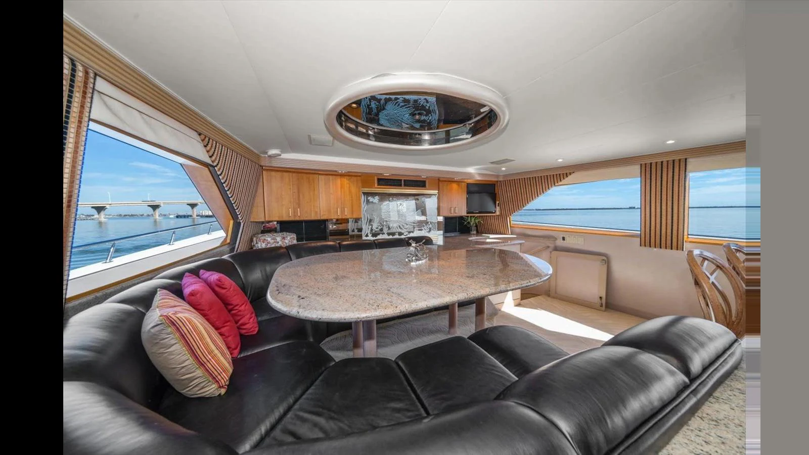 The salon features a luxurious seating area with a large dining table and panoramic windows offering stunning views. aboard THINK B.I.G Yacht for Sale