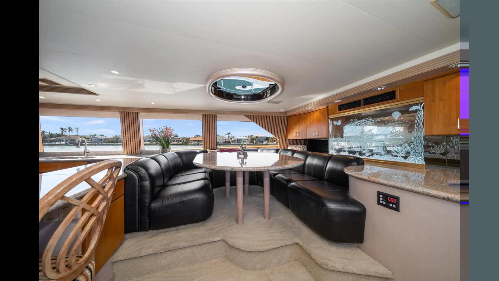 The salon features a spacious seating area with luxurious leather couches and a stylish dining table. aboard THINK B.I.G Yacht for Sale