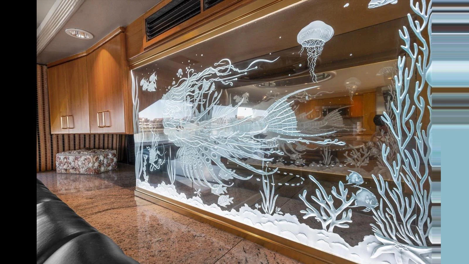 The interior features a beautifully etched glass panel with an aquatic theme, adding an artistic touch to the yacht's decor. aboard THINK B.I.G Yacht for Sale