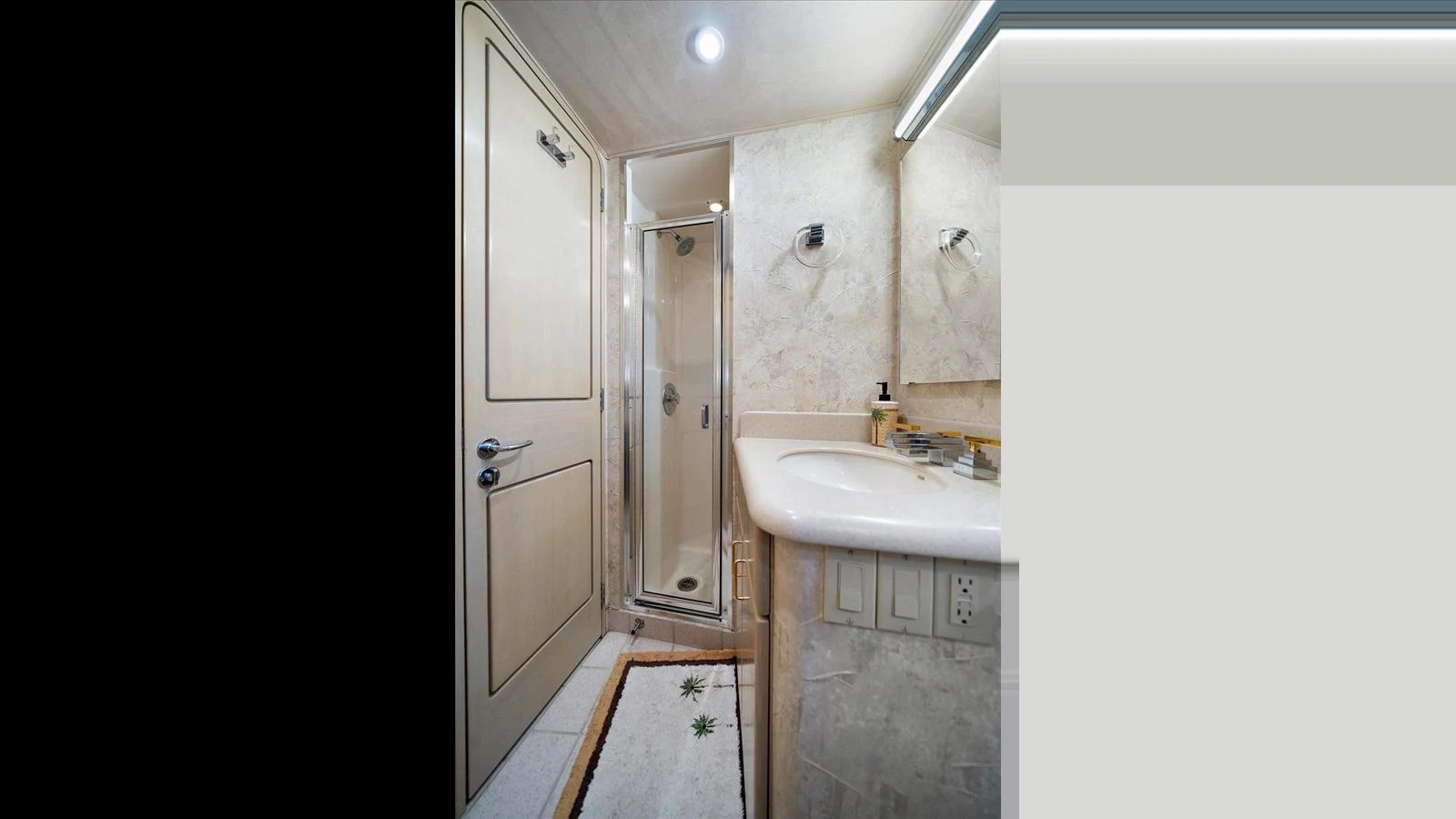 A well-appointed yacht bathroom with a shower, sink, and elegant fixtures. aboard THINK B.I.G Yacht for Sale