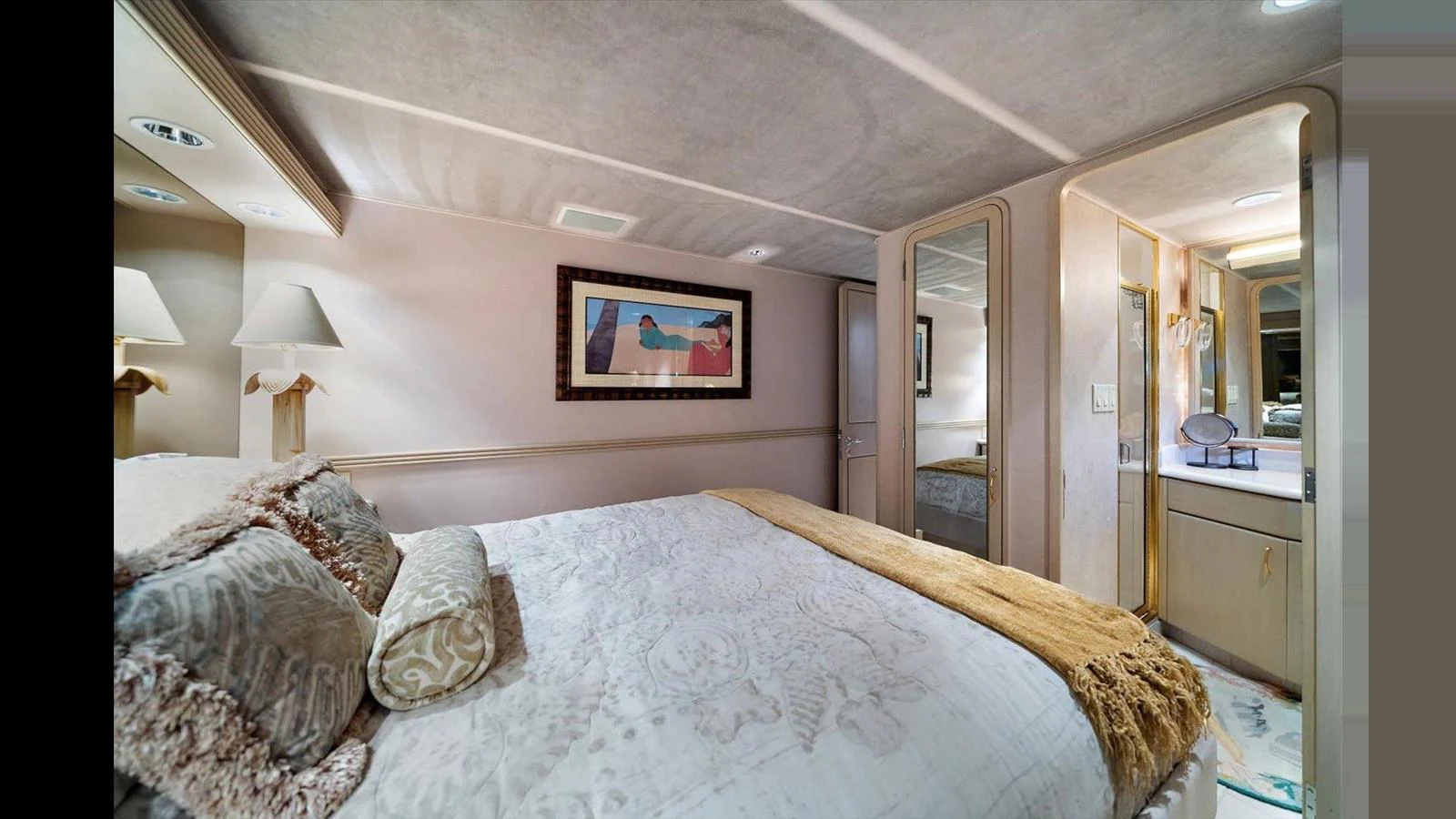 A luxurious stateroom featuring a plush bed with elegant bedding and soft lighting. aboard THINK B.I.G Yacht for Sale