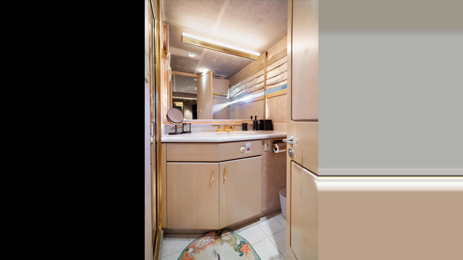 The yacht's bathroom features elegant fixtures and a well-lit vanity area. aboard THINK B.I.G Yacht for Sale