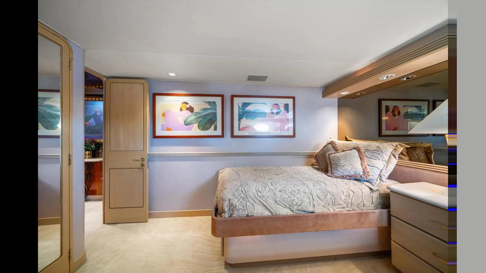 The stateroom features a plush bed with elegant bedding and tasteful artwork on the walls. aboard THINK B.I.G Yacht for Sale