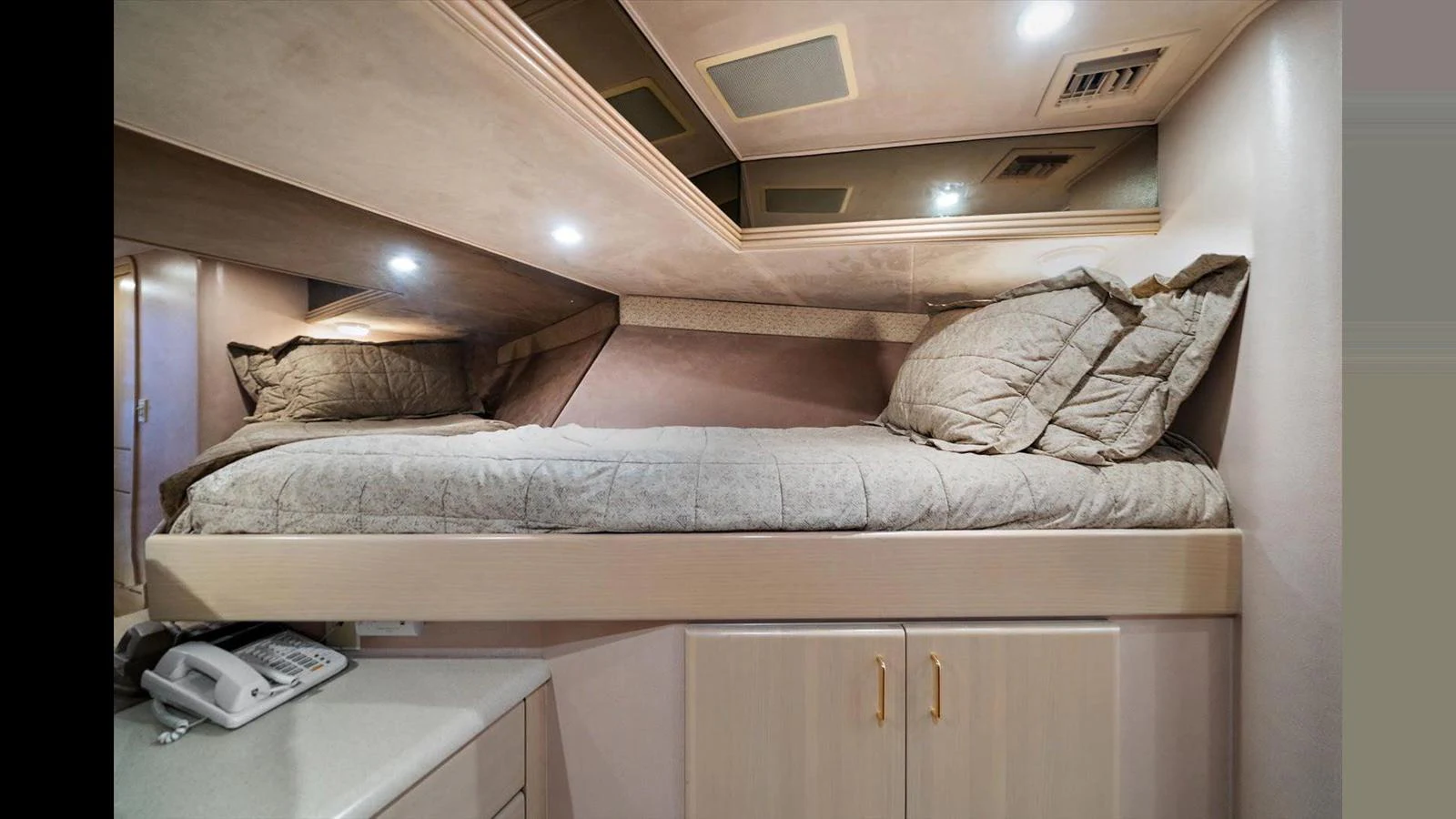 The image showcases a cozy cabin with a comfortable bed and modern amenities. aboard THINK B.I.G Yacht for Sale