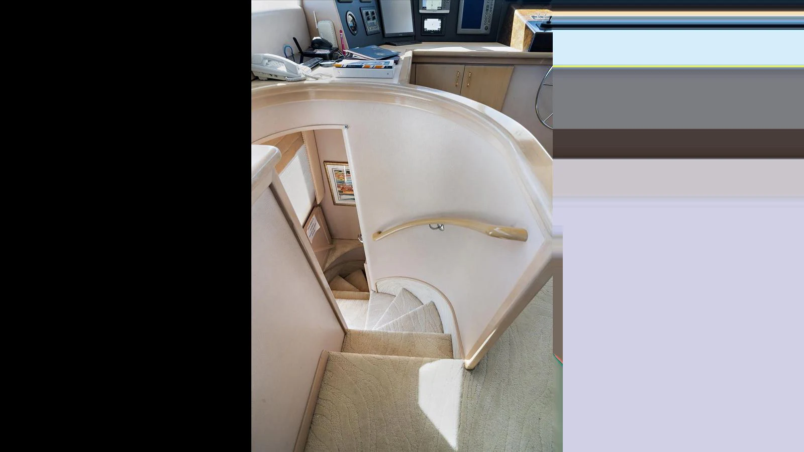 A luxurious interior staircase with elegant handrails and soft carpeting. aboard THINK B.I.G Yacht for Sale