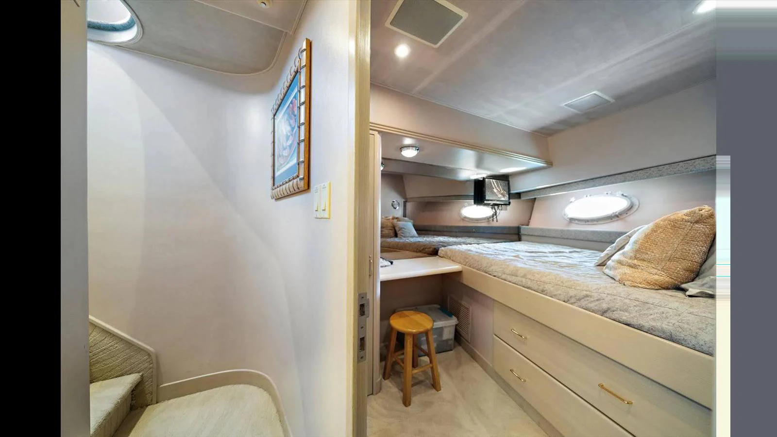 A cozy guest stateroom with a comfortable bed and soft lighting. aboard THINK B.I.G Yacht for Sale