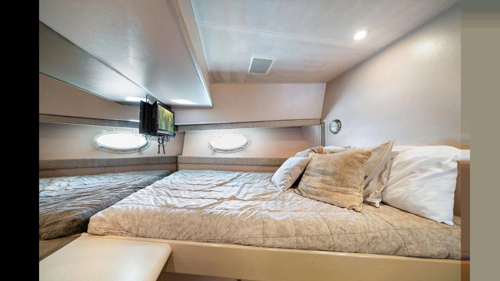 A cozy stateroom featuring a comfortable bed with soft pillows and ambient lighting. aboard THINK B.I.G Yacht for Sale