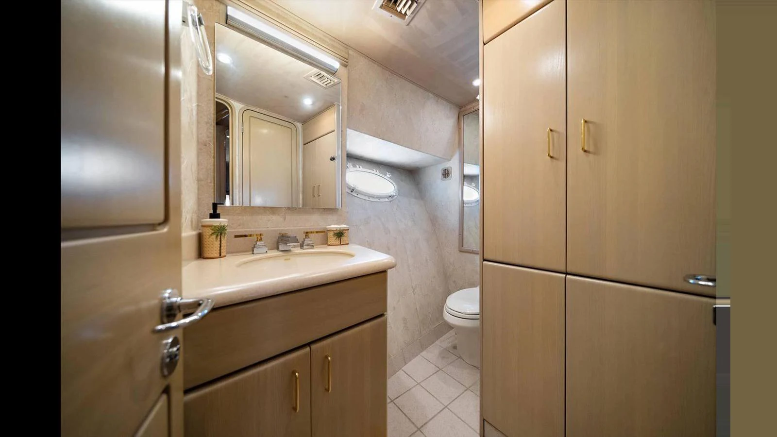 The yacht's bathroom features elegant cabinetry and modern fixtures, creating a luxurious and functional space. aboard THINK B.I.G Yacht for Sale