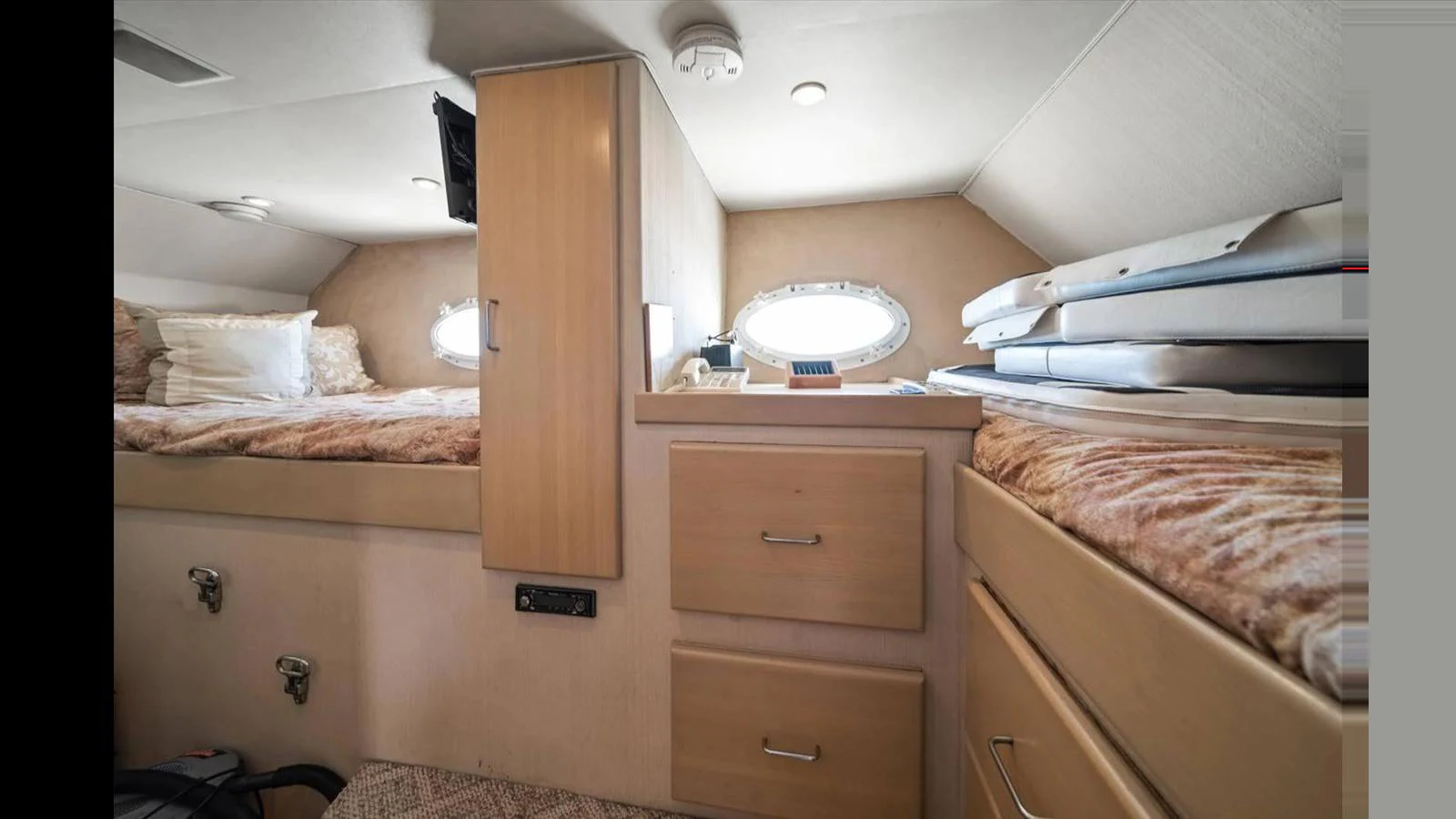 A cozy cabin with twin beds and ample storage space, perfect for a comfortable stay. aboard THINK B.I.G Yacht for Sale