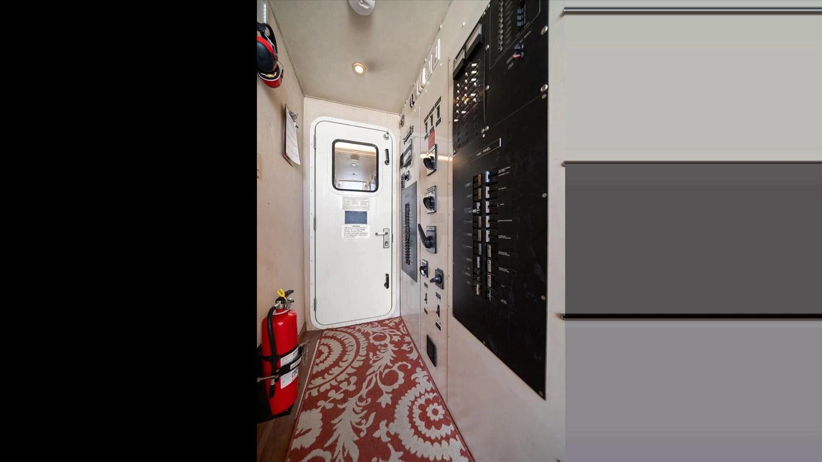 The yacht's control room features essential electrical panels and safety equipment. aboard THINK B.I.G Yacht for Sale