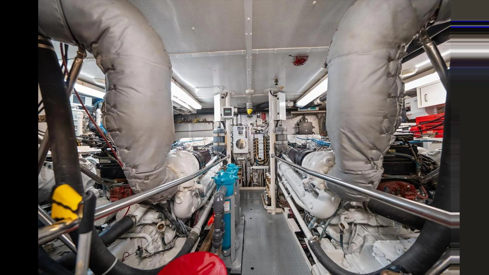 The image showcases the well-maintained engine room of the yacht, highlighting its powerful machinery and organized layout. aboard THINK B.I.G Yacht for Sale
