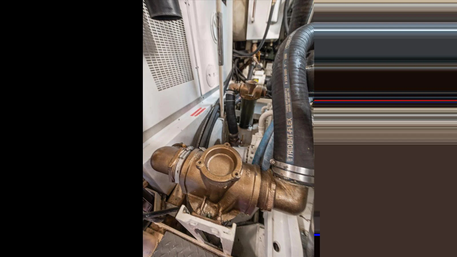 A close-up view of the yacht's engine room showcasing mechanical components and piping. aboard THINK B.I.G Yacht for Sale
