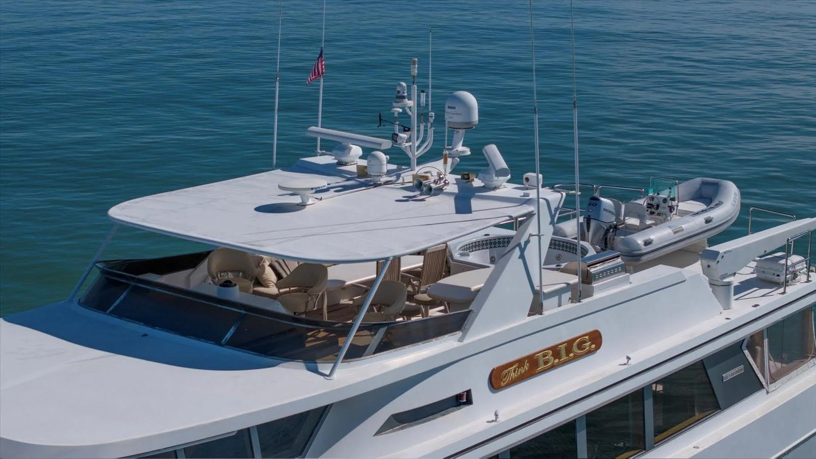 The yacht's flybridge offers a spacious and well-equipped area for relaxation and navigation. aboard THINK B.I.G Yacht for Sale