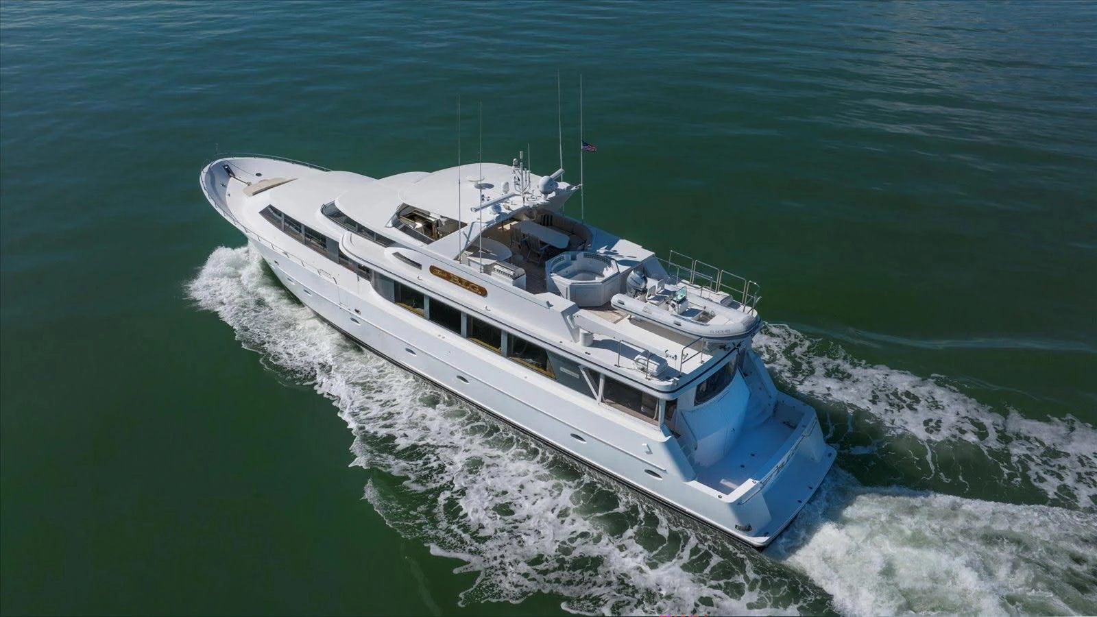 A sleek and elegant yacht glides smoothly through the water, showcasing its luxurious design and spacious decks. aboard THINK B.I.G Yacht for Sale