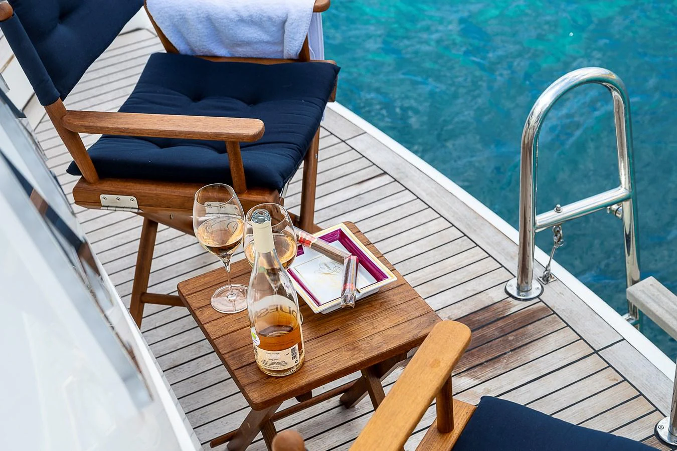 a glass of beer on a table aboard AXEBT Yacht for Sale