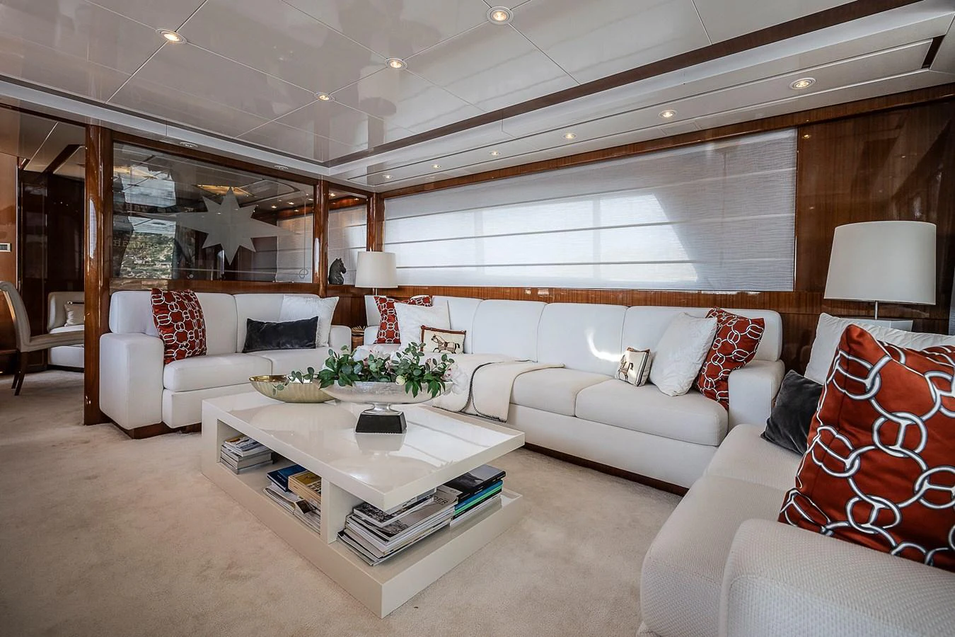 a living room with a white couch and a coffee table aboard AXEBT Yacht for Sale