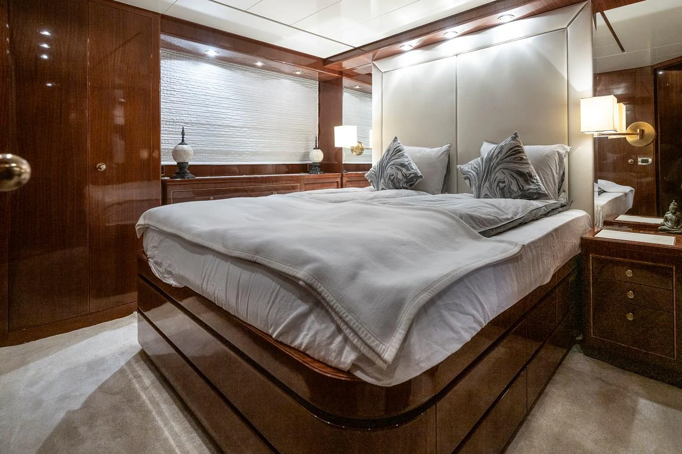 a bed with a white comforter aboard AXEBT Yacht for Sale