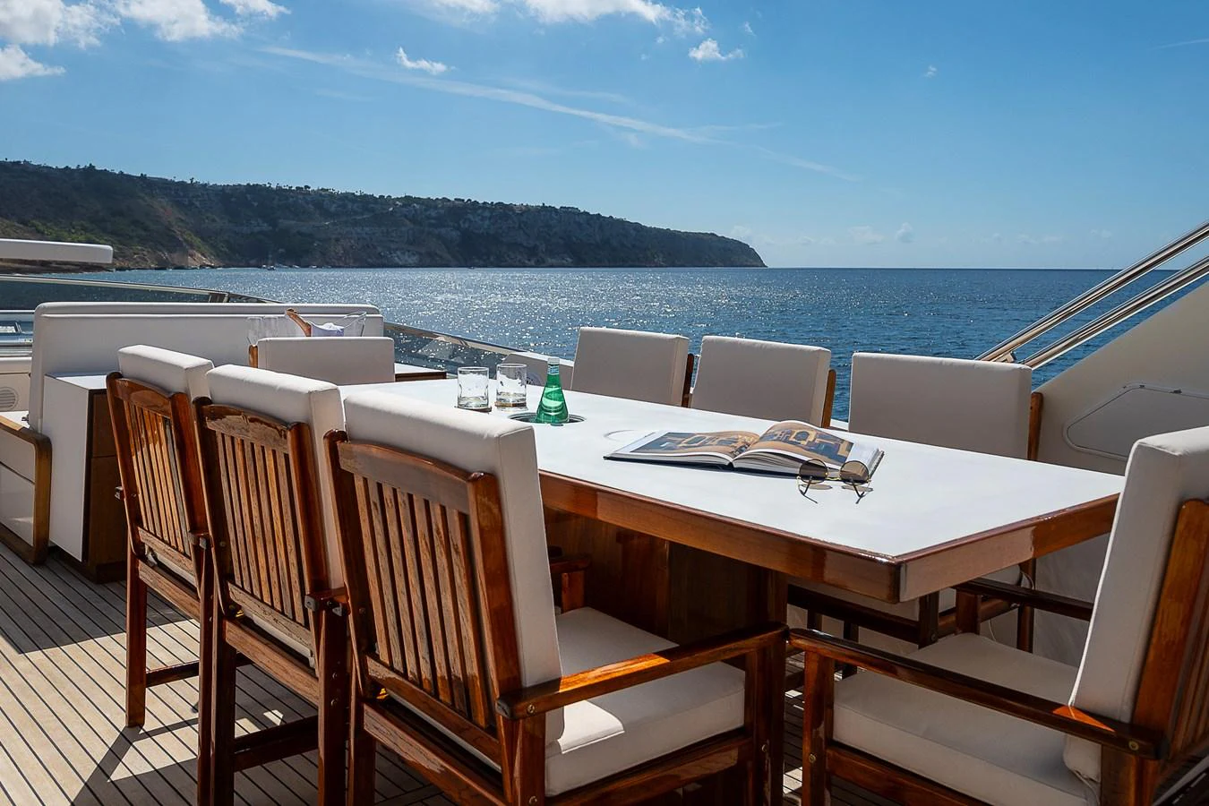 a table with chairs on it aboard AXEBT Yacht for Sale