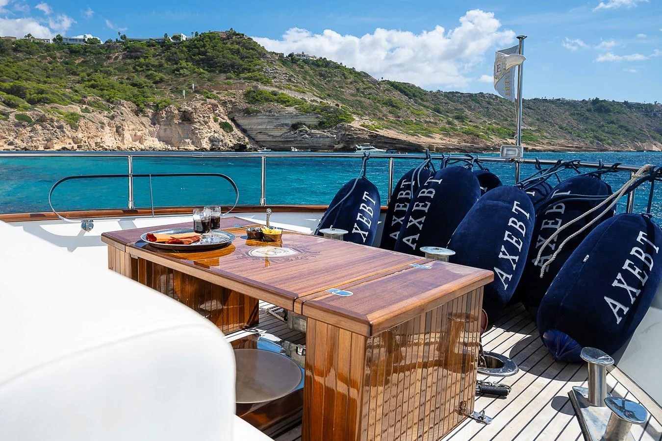 a table with a blue hat and a blue blanket on it aboard AXEBT Yacht for Sale