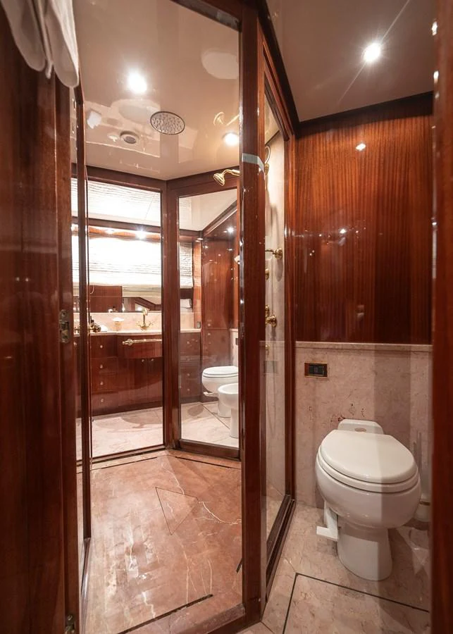 a bathroom with a toilet and a sink aboard AXEBT Yacht for Sale