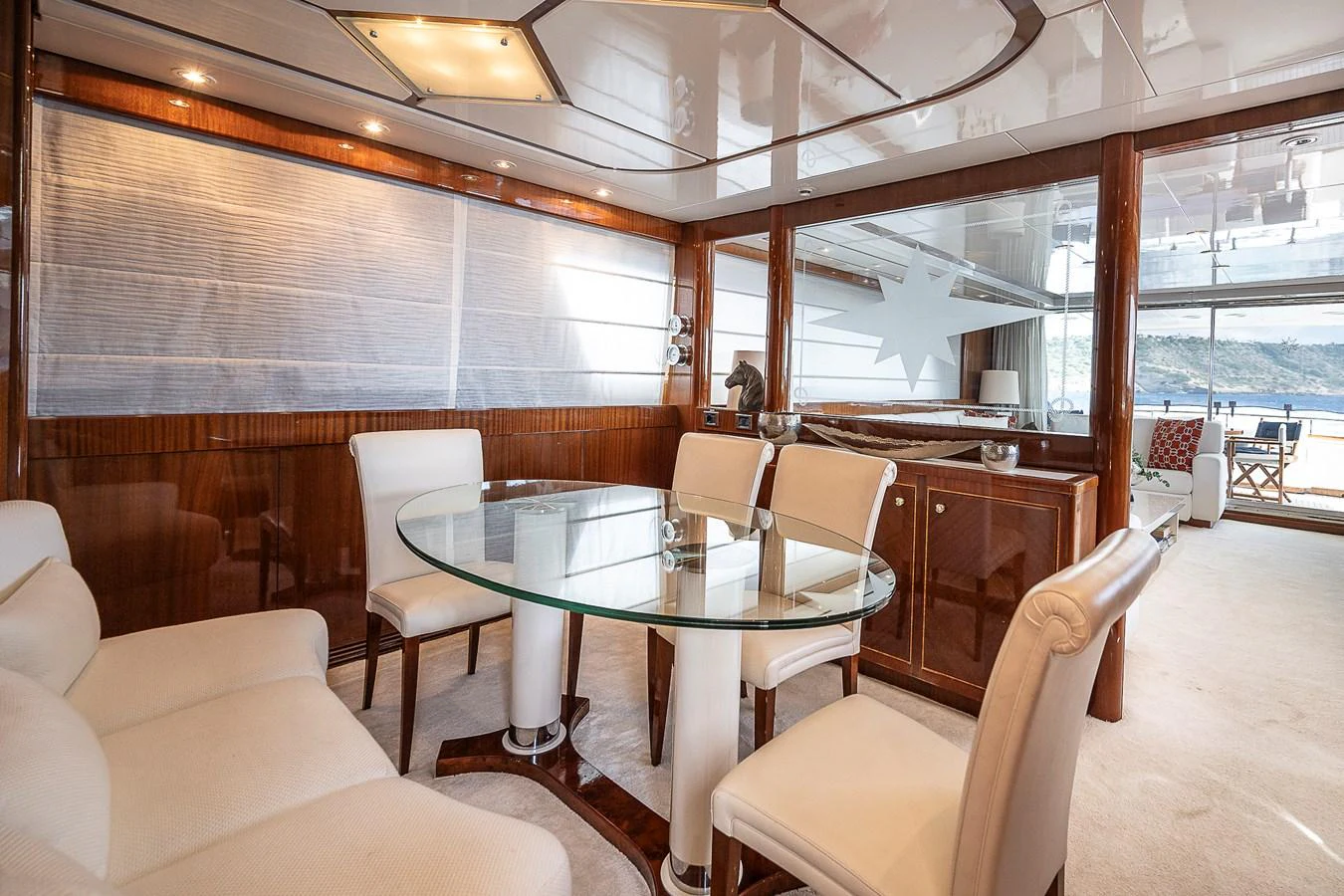 a room with a table chairs and a large window aboard AXEBT Yacht for Sale