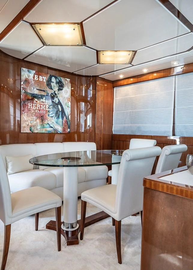a room with a table and chairs aboard AXEBT Yacht for Sale