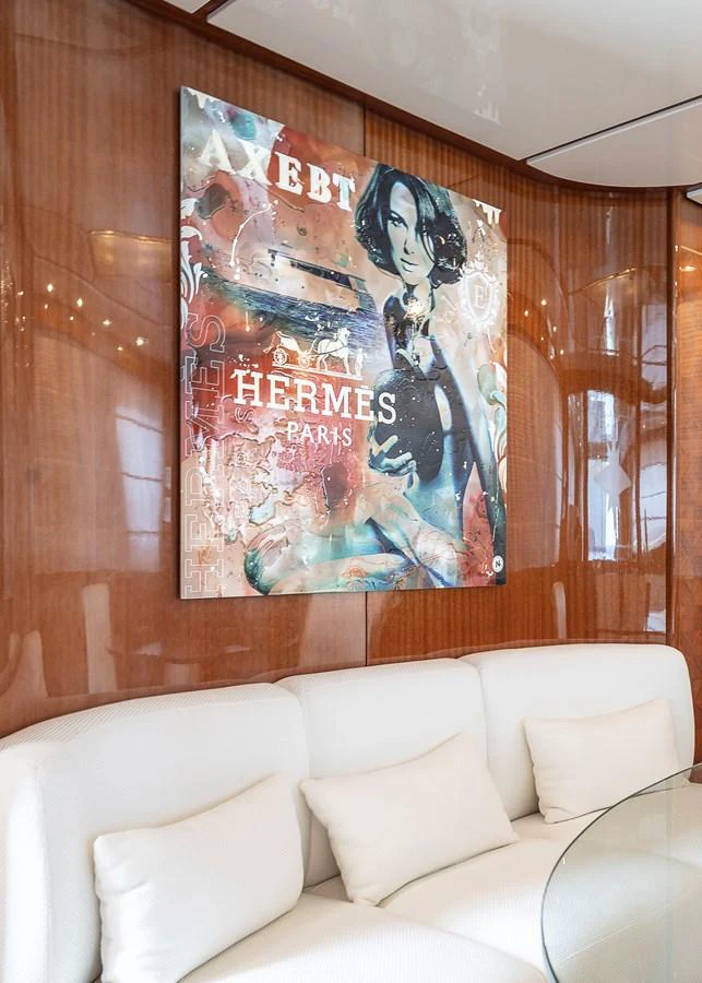a couch with a poster on it aboard AXEBT Yacht for Sale
