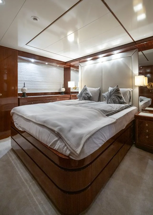 a bed with a white comforter aboard AXEBT Yacht for Sale