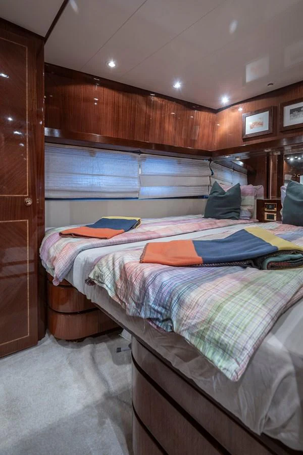 a bed with a blue sheet aboard AXEBT Yacht for Sale