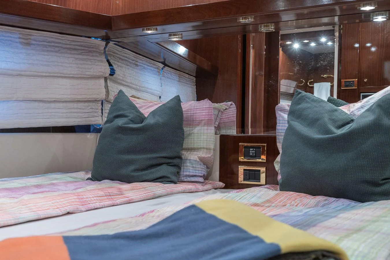 a bed with pillows and blankets aboard AXEBT Yacht for Sale