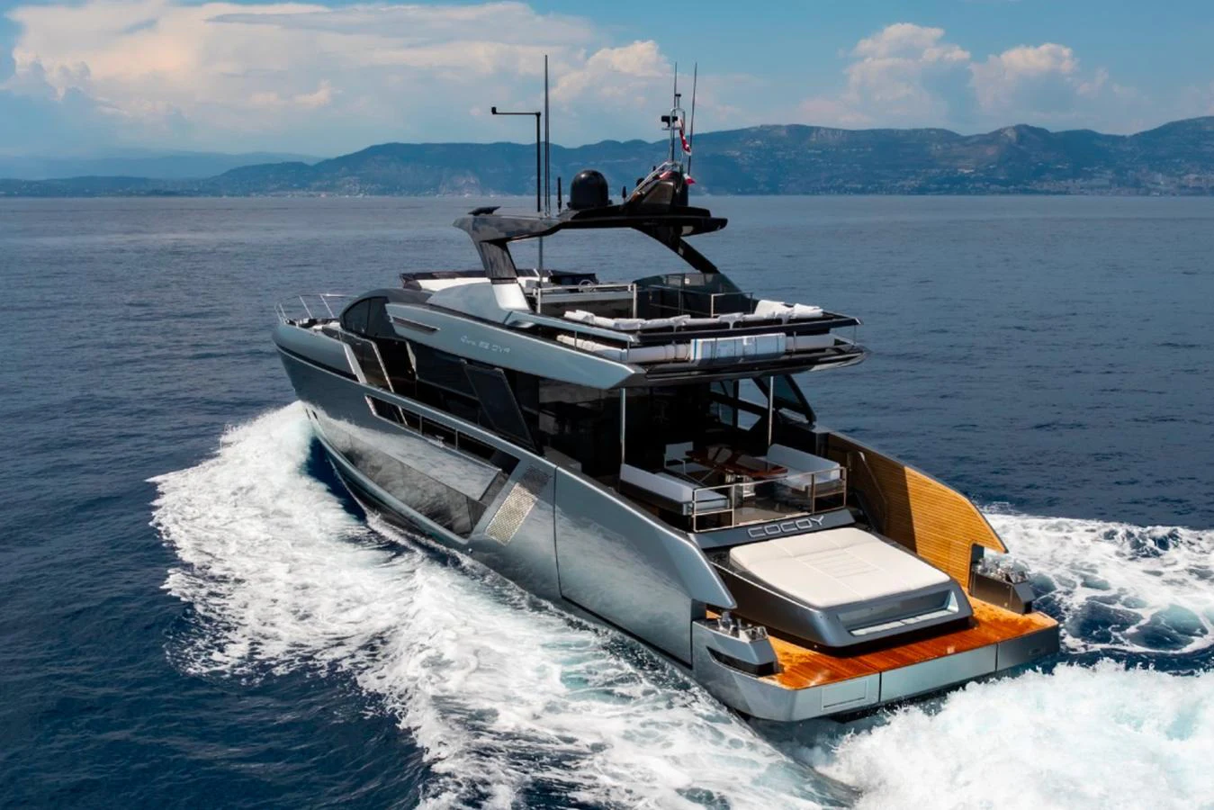A sleek and modern yacht cruises through the open water, showcasing its stylish design and spacious deck areas. aboard COCO Y Yacht for Sale