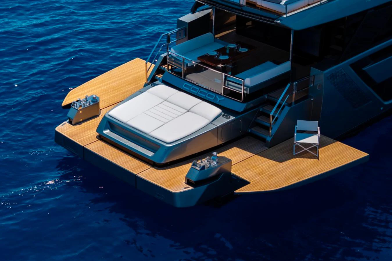 The yacht's aft deck features a spacious lounging area with elegant teak decking and direct access to the water. aboard COCO Y Yacht for Sale