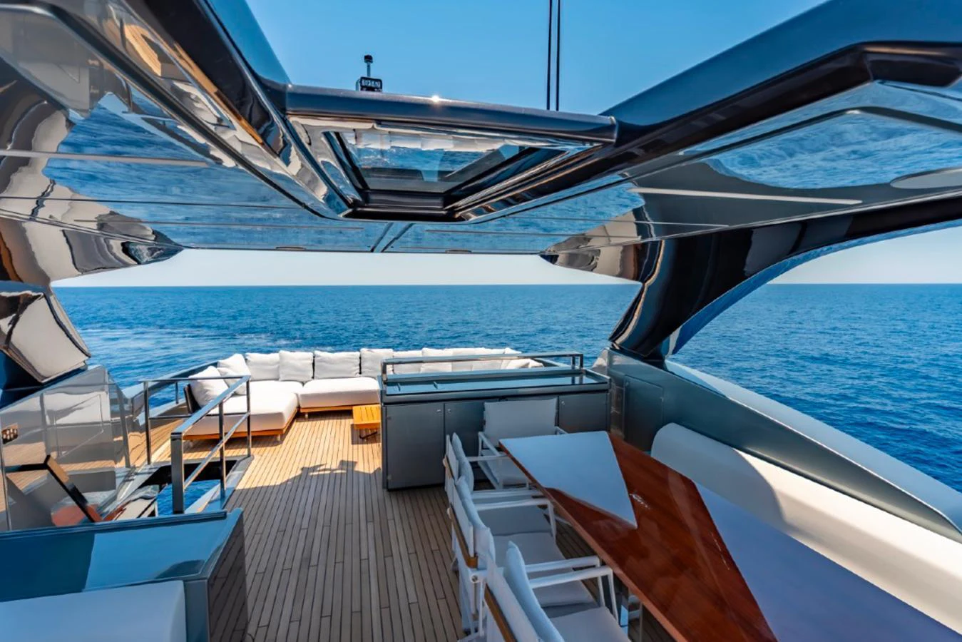 The aft deck offers a luxurious outdoor seating area with stunning ocean views. aboard COCO Y Yacht for Sale
