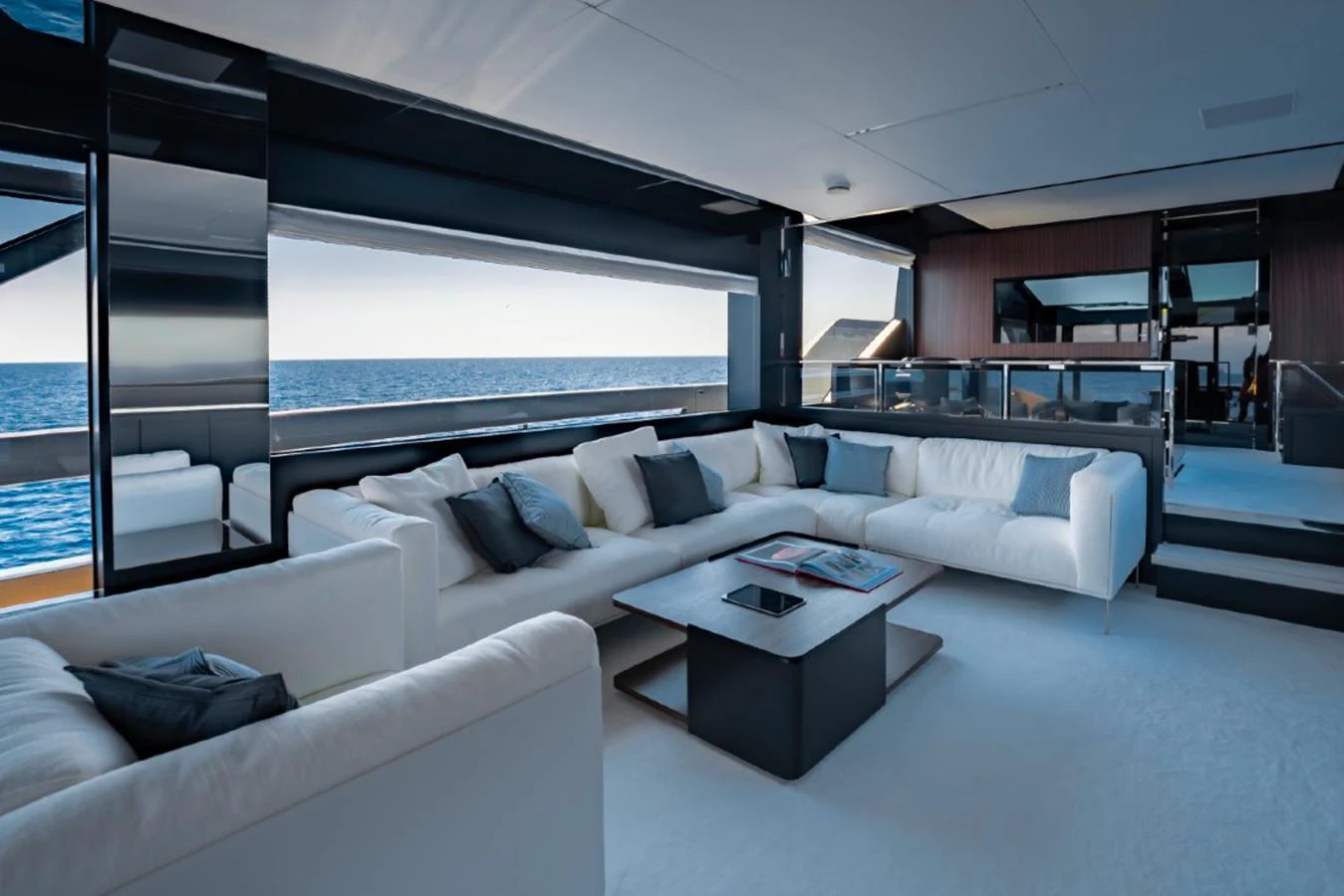 The salon offers a spacious and modern lounging area with panoramic ocean views. aboard COCO Y Yacht for Sale