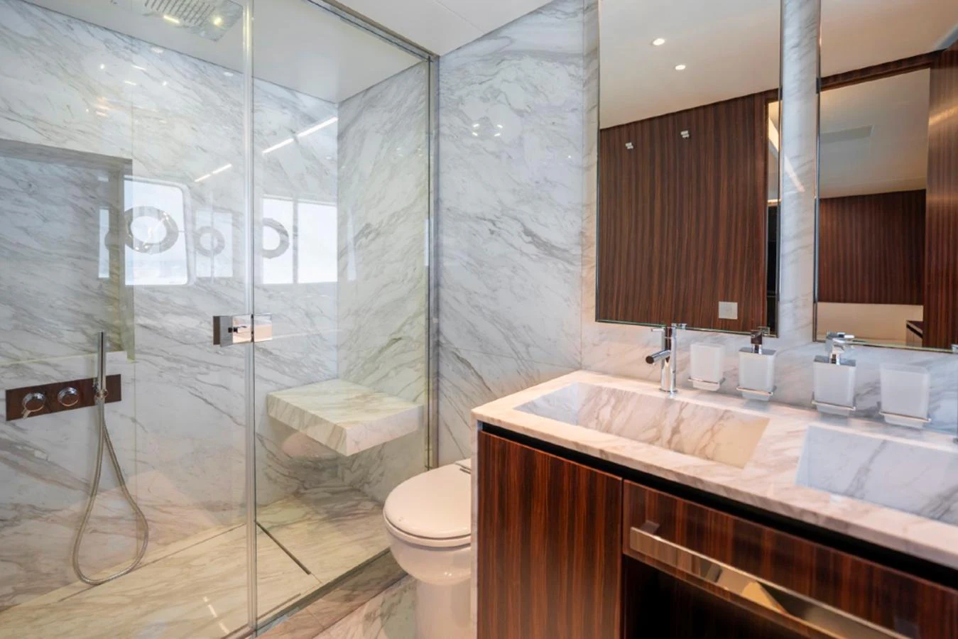 The yacht's bathroom features elegant marble surfaces and modern fixtures. aboard COCO Y Yacht for Sale