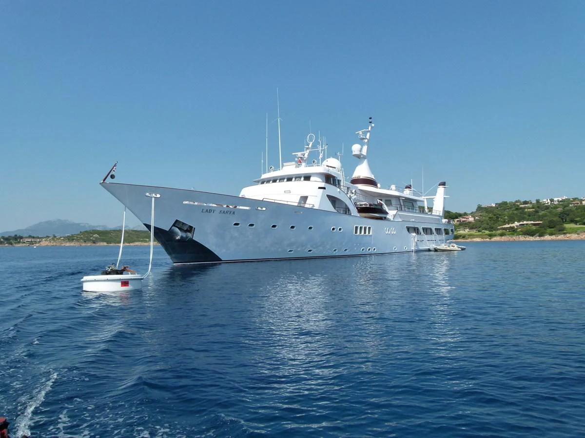 A majestic yacht is anchored in calm waters, showcasing its sleek design and luxurious features. aboard LADY SARYA Yacht for Sale