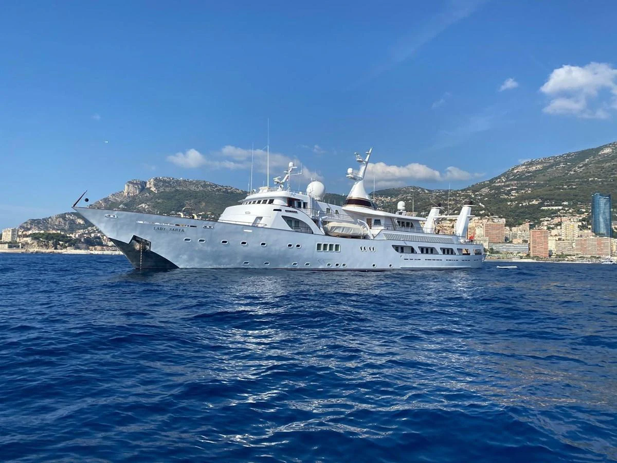 A classic yacht cruises gracefully on the open water against a scenic coastal backdrop. aboard LADY SARYA Yacht for Sale