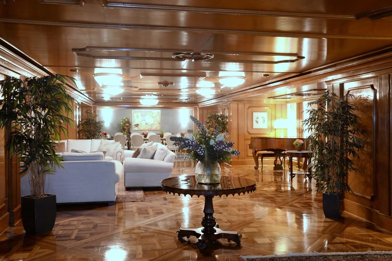The yacht's salon features elegant wood paneling, plush seating, and tasteful decor, creating a luxurious and inviting atmosphere. aboard LADY SARYA Yacht for Sale