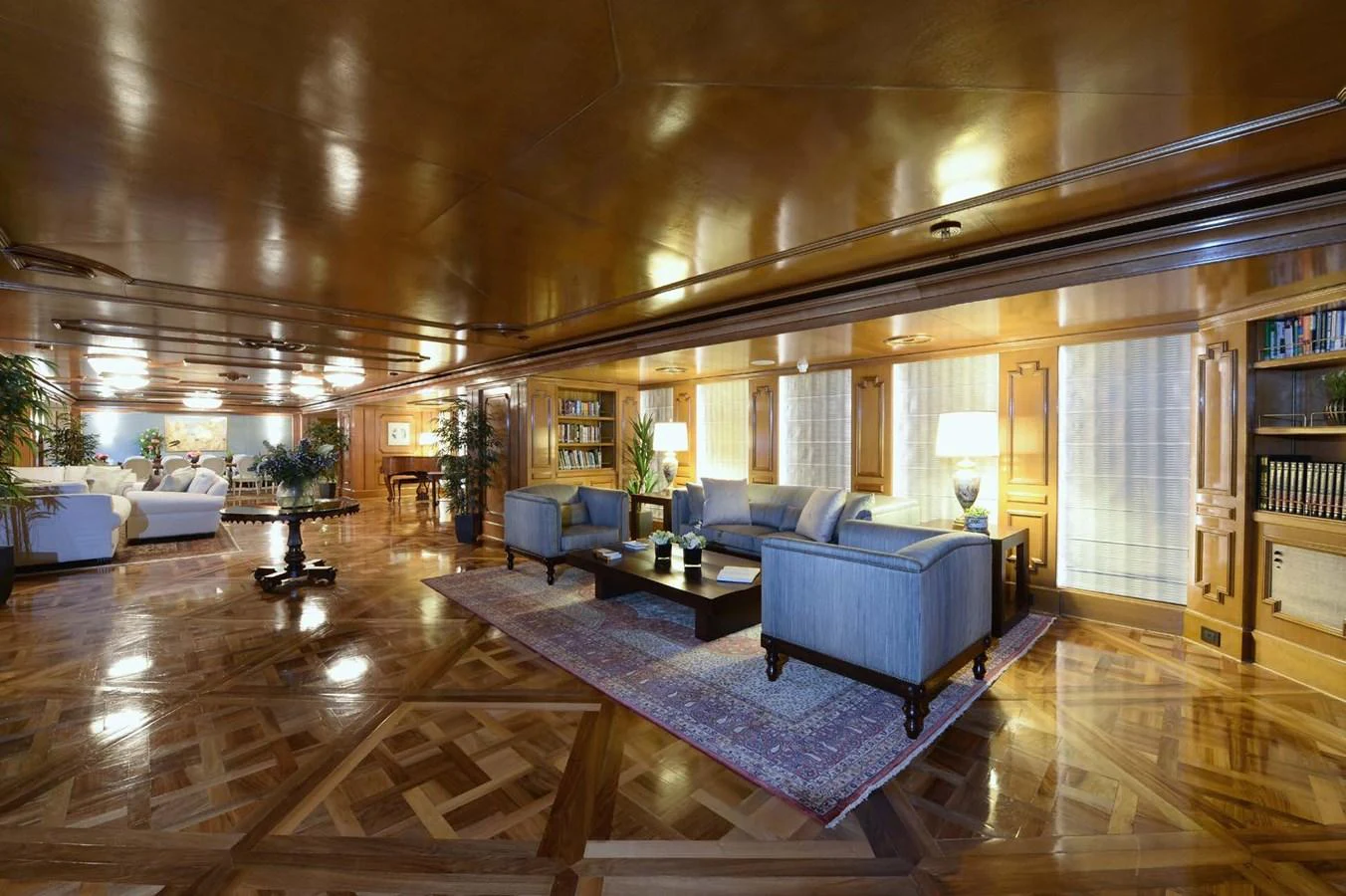 The yacht's salon features elegant wood paneling, plush seating, and a sophisticated ambiance. aboard LADY SARYA Yacht for Sale