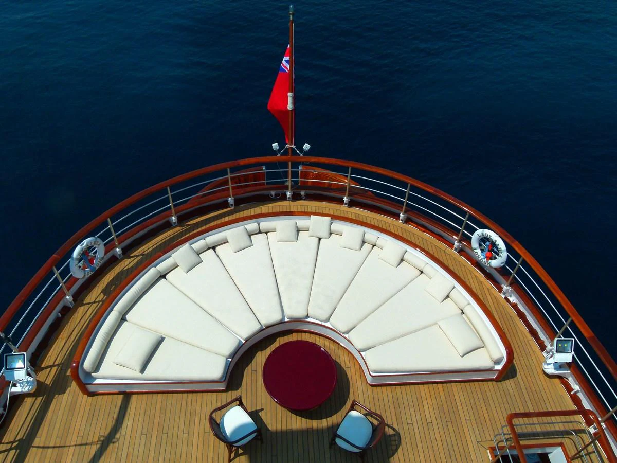 The aft deck features a spacious, curved seating area with a stunning view of the open water. aboard LADY SARYA Yacht for Sale
