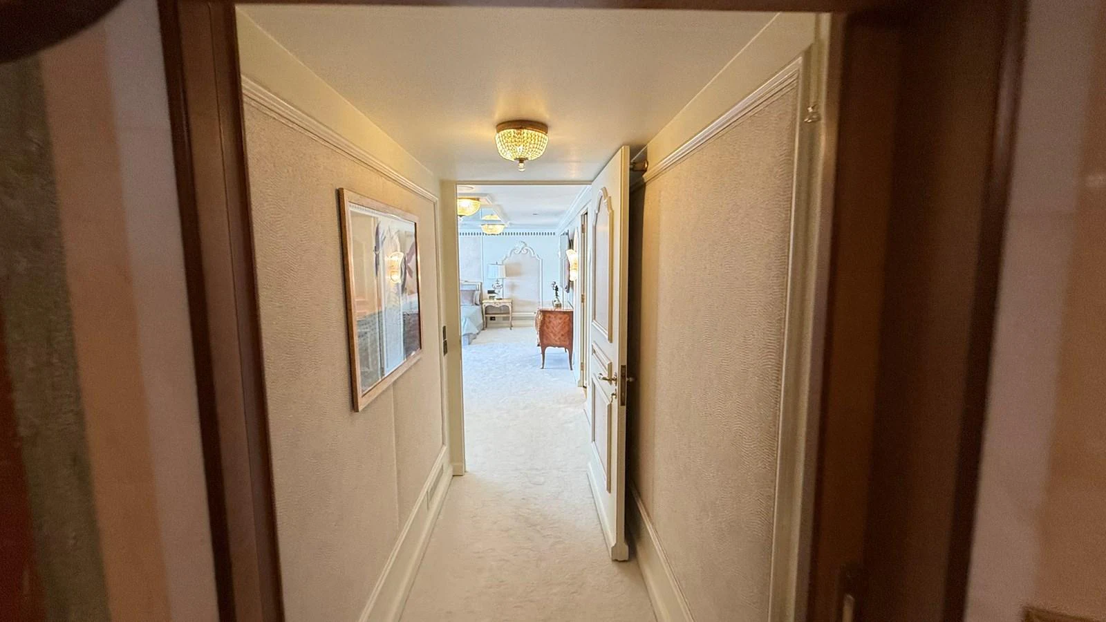 A luxurious hallway leading to a well-appointed room with elegant furnishings. aboard LADY SARYA Yacht for Sale