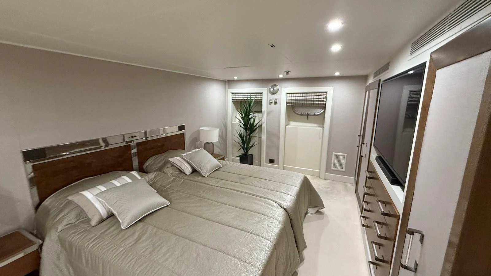 The guest stateroom features twin beds, modern decor, and ample storage space. aboard LADY SARYA Yacht for Sale
